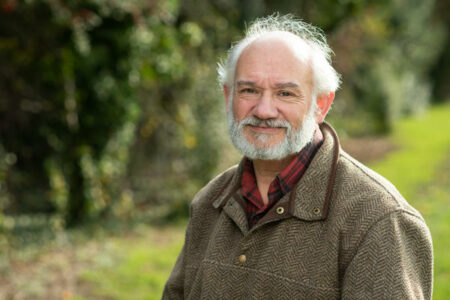 head and shoulders with blurred greenery in the backgroud