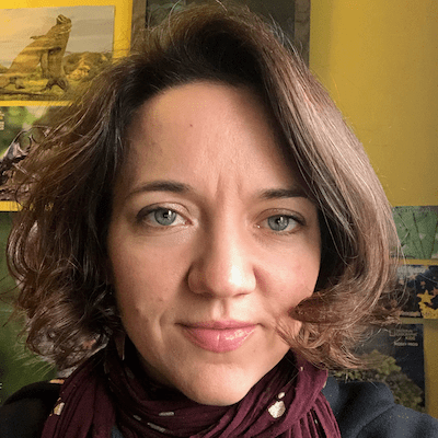 Emily in front of a yellow all