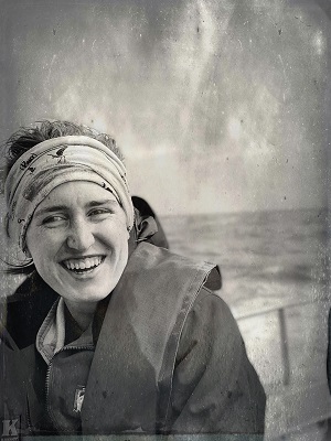 woman with scarf around head laughing